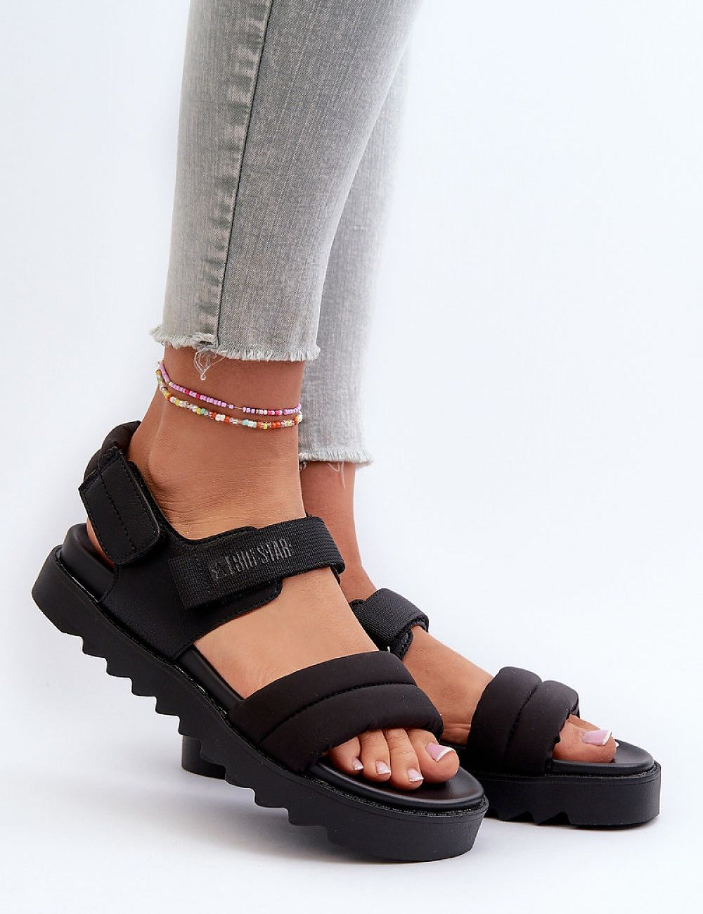 Black Rivexa platform strap sandals on feet, showcasing textured fabric and eco leather design with practical Velcro fastening, perfect for urban wear.
