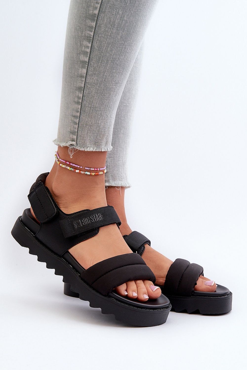 Black Rivexa platform strap sandals on feet, showcasing textured fabric and eco leather design with practical Velcro fastening, perfect for urban wear.