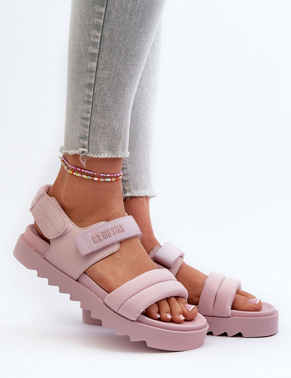 Person wearing pink Rivexa Platform Strap Sandals with Velcro fastening and platform sole, paired with denim jeans.