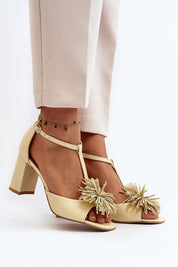 Woman wearing Alessira Post-Heel Leather Sandals with delicate front ornament and adjustable ankle strap for a refined look.