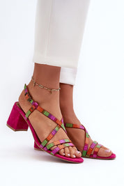Colorful strappy leather sandals with mid-heel and ankle bracelet, styled with white trousers for summer elegance.