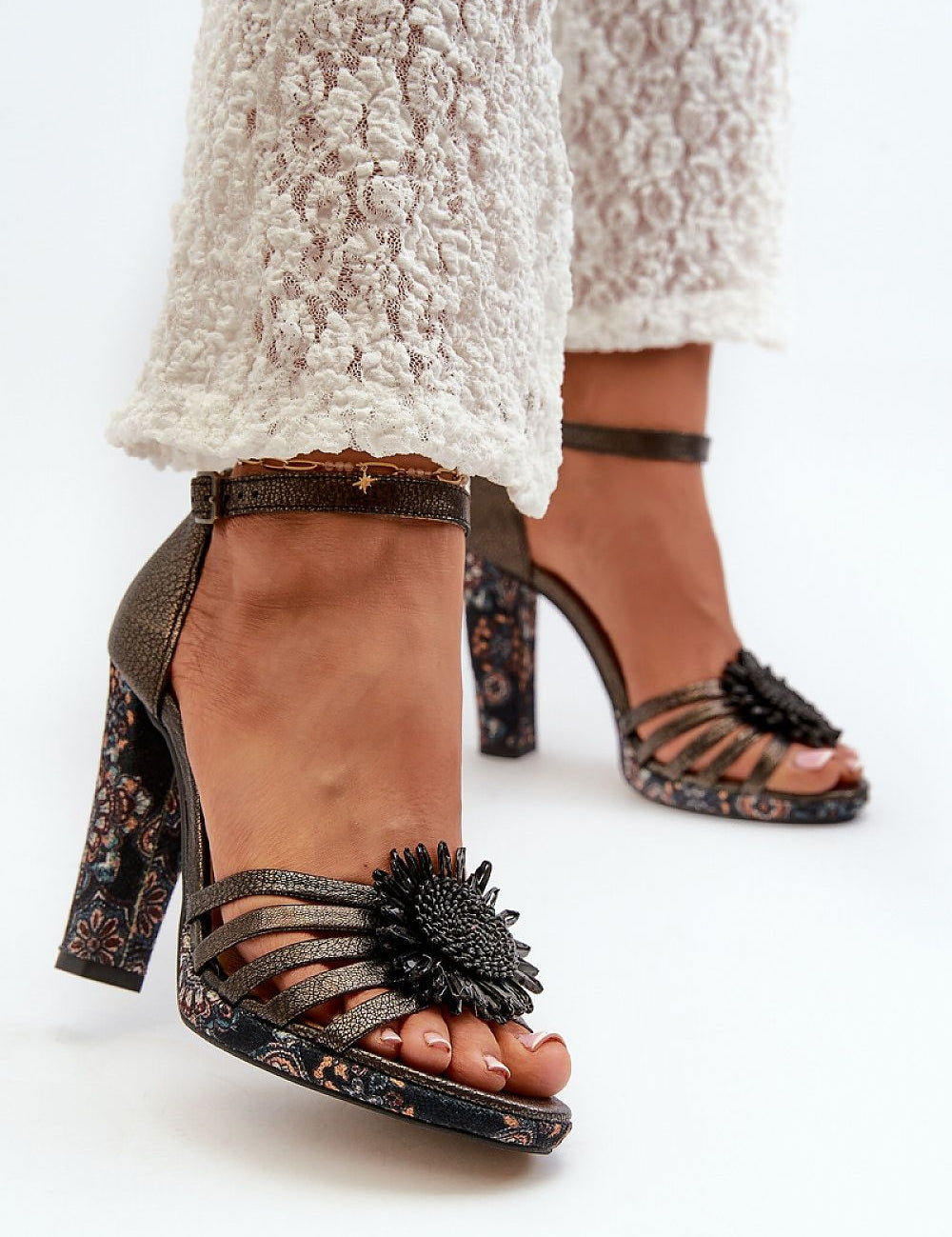 Lysoria Sculpted Leather Sandals featuring high heels, ankle straps, and floral embellishments, elegant and sophisticated footwear design.