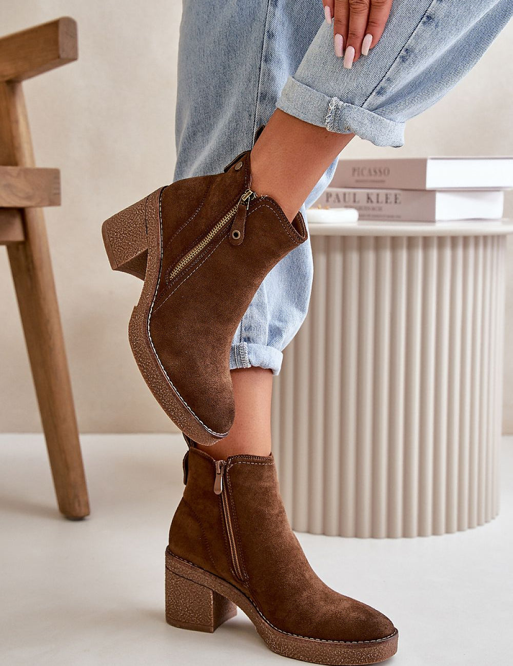 Brown eco suede ankle boots with block heel and side zipper, modeled with cuffed jeans, showcasing autumn fashion.