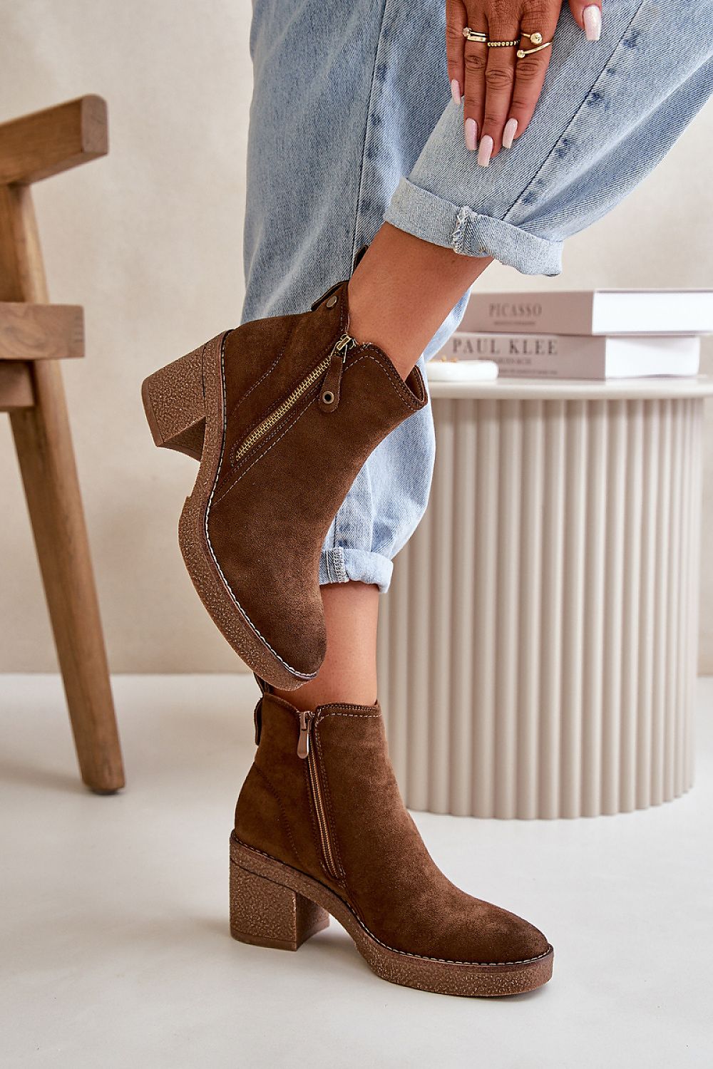 Brown eco suede ankle boots with block heel and side zipper, modeled with cuffed jeans, showcasing autumn fashion.