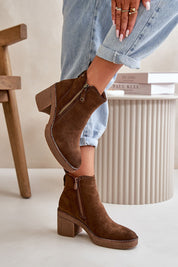 Brown eco suede ankle boots with block heel and side zipper, modeled with cuffed jeans, showcasing autumn fashion.
