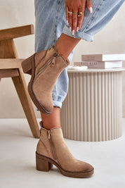 Woman wearing Sylmara Hearthstep suede ankle boots with block heel and side zipper, ideal for autumn and winter fashion.