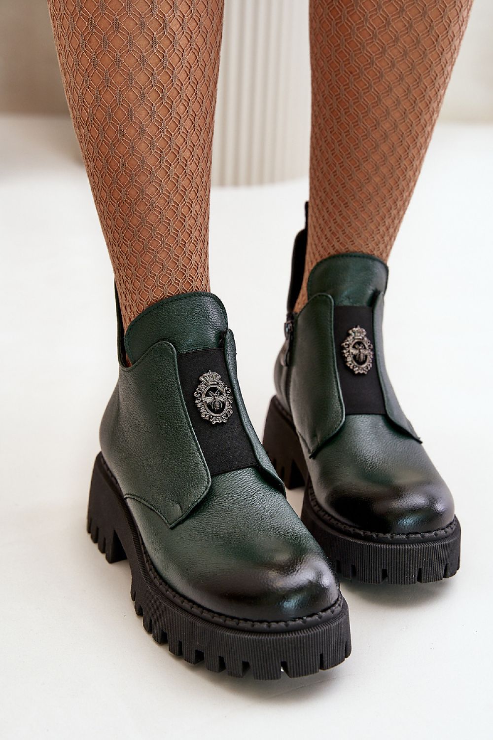 Virelsa Cresthold ankle boots in green leather with chunky heel and grooved platform, featuring an elastic insert with sculptural embellishment.