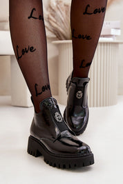 Virelsa Cresthold Leather Form ankle boots with chunky heel and sculptural embellishment, worn with 'Love' patterned tights.