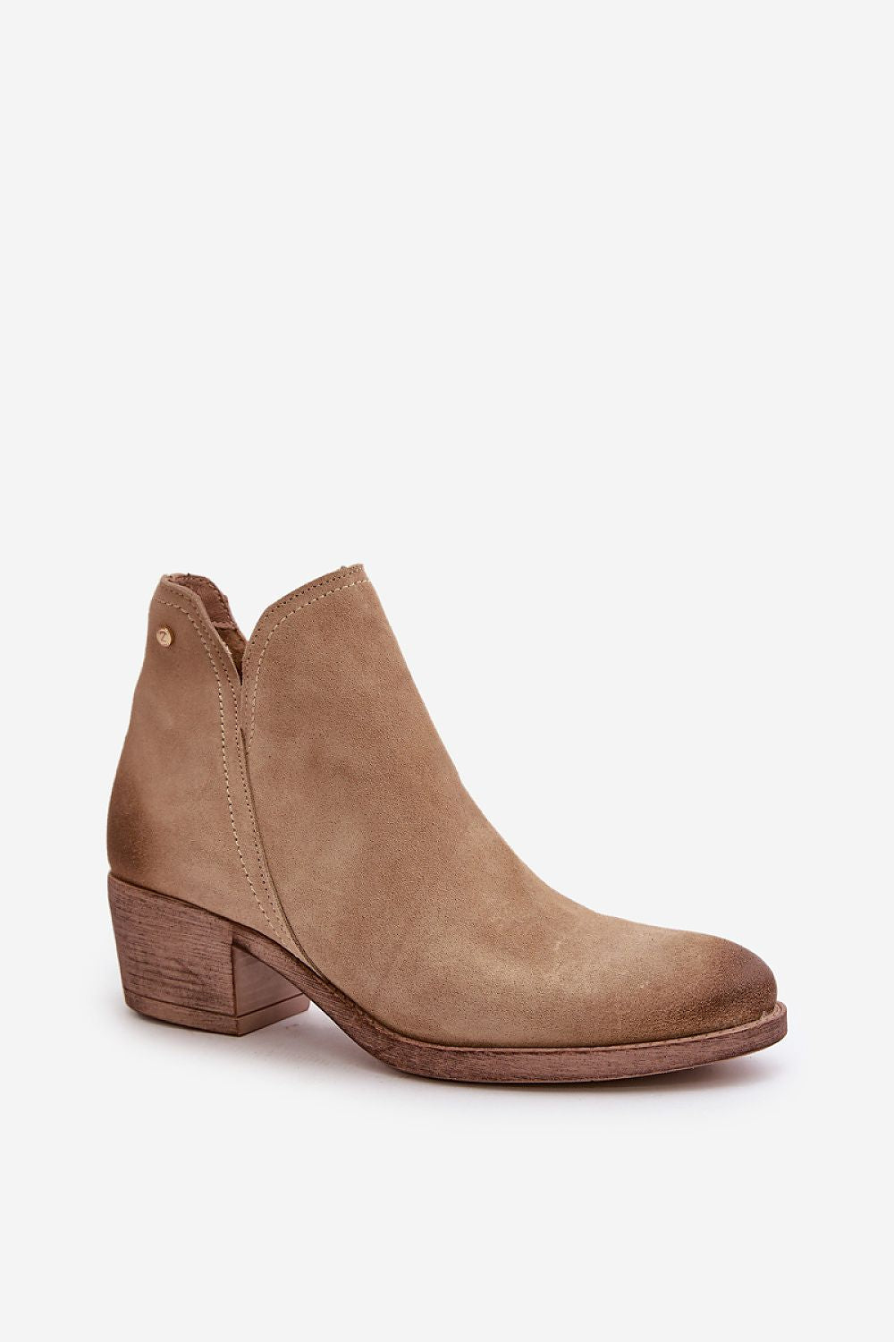 Natural suede ankle boot with cutout design, mid-height heel, rounded toe, and side zipper for easy closure. Perfect for cool-season wear.