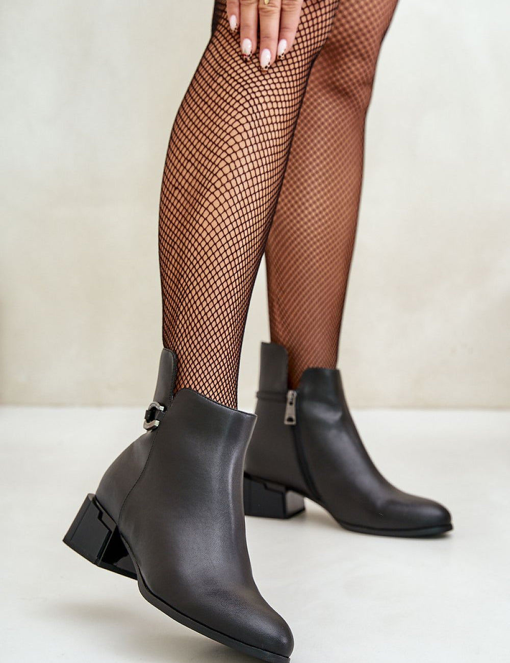 Malvory Sleek High-Heel Ankle Boots in smooth leather with decorative strap, showcasing refined ankle-length design and side zipper.