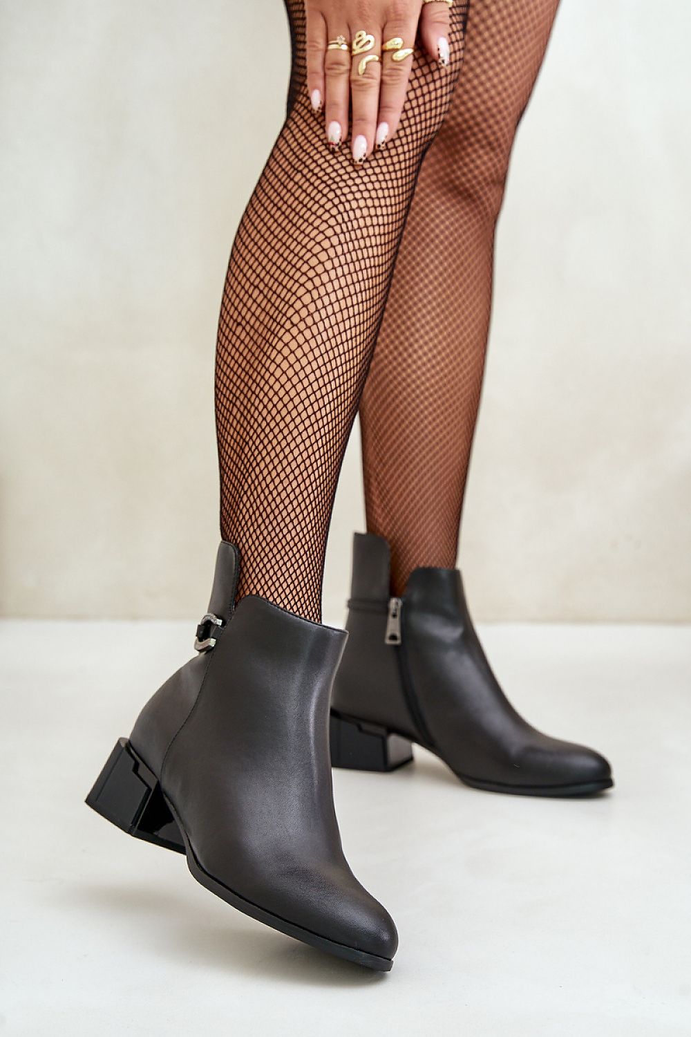 Malvory Sleek High-Heel Ankle Boots in smooth leather with decorative strap, showcasing refined ankle-length design and side zipper.