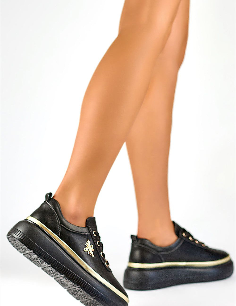 Black Valmerra Classic Platform Sneakers with gold accents, featuring a sculpted 5 cm platform and premium leather, shown in profile view.