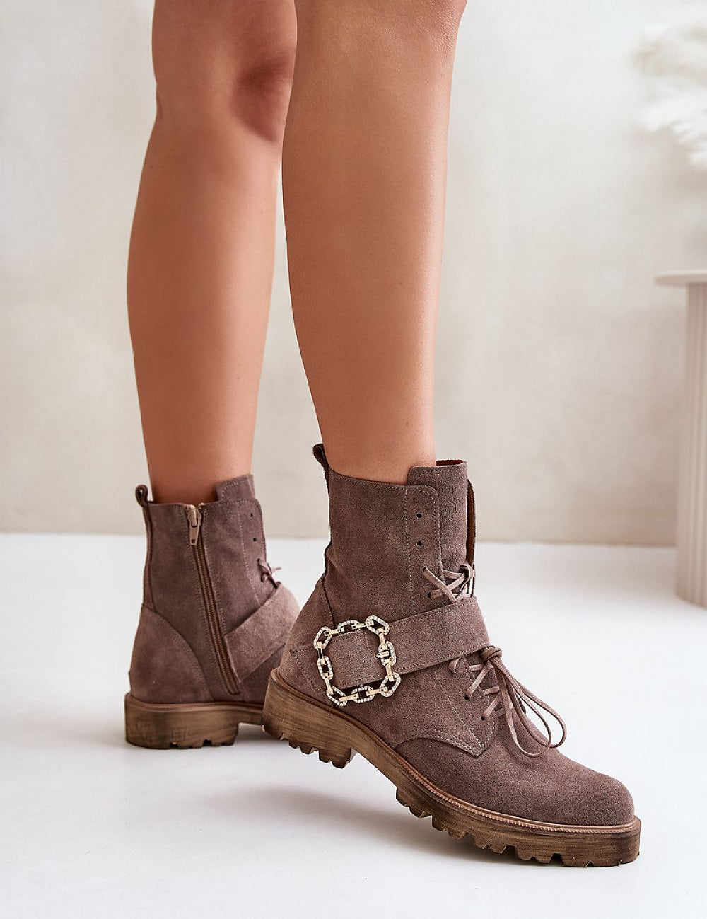 Bravura suede ankle boots with buckle, flat sole, and side zipper, offering durability and style for all-day comfort.