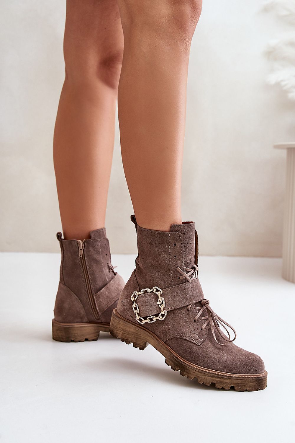 Bravura suede ankle boots with buckle, flat sole, and side zipper, offering durability and style for all-day comfort.