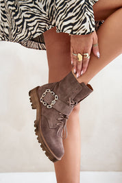 Bravura suede ankle boots with buckle and laces on model wearing zebra print dress.