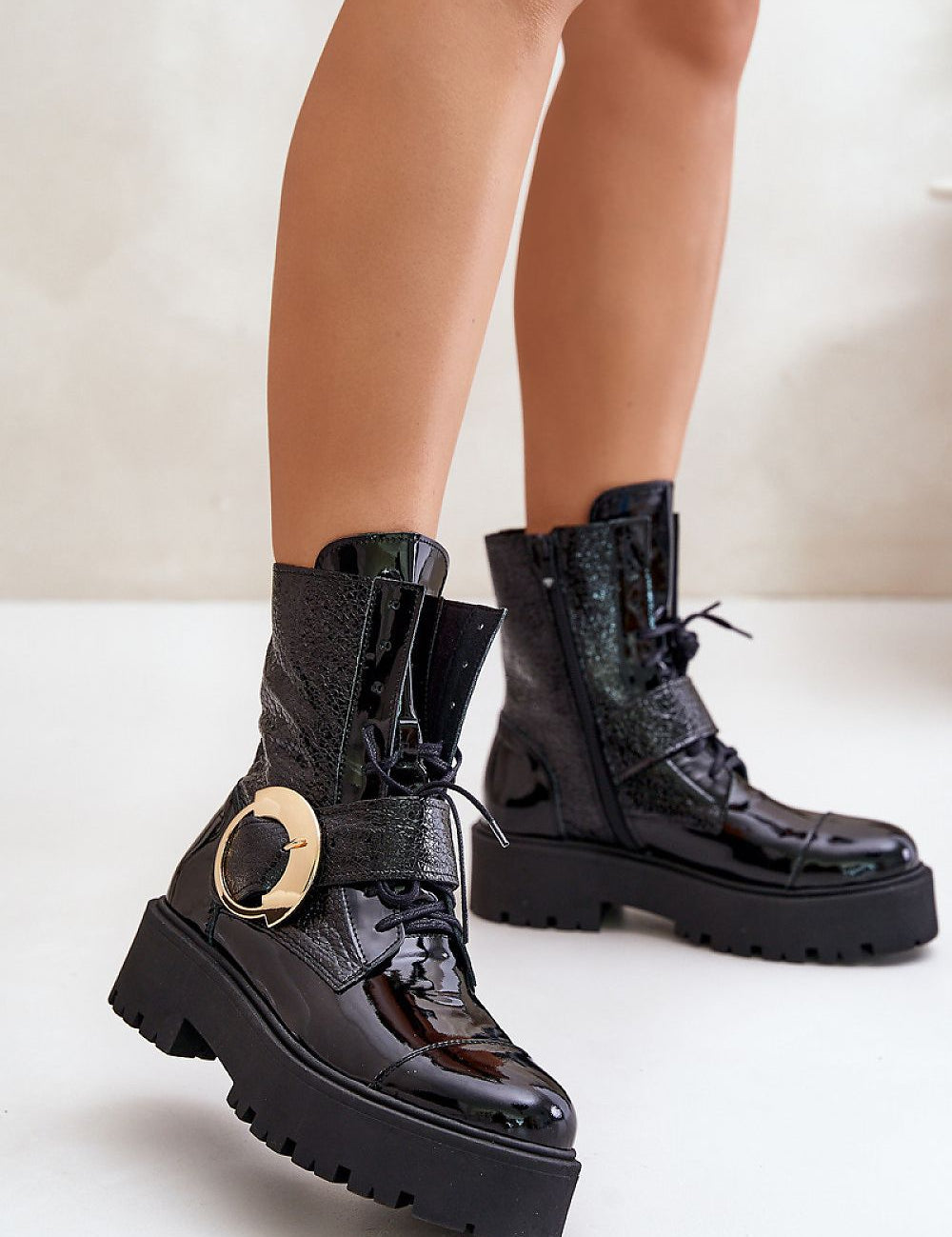 Bravora black leather boots with buckle and platform, featuring side zipper and lace-up front for secure fit on white background.