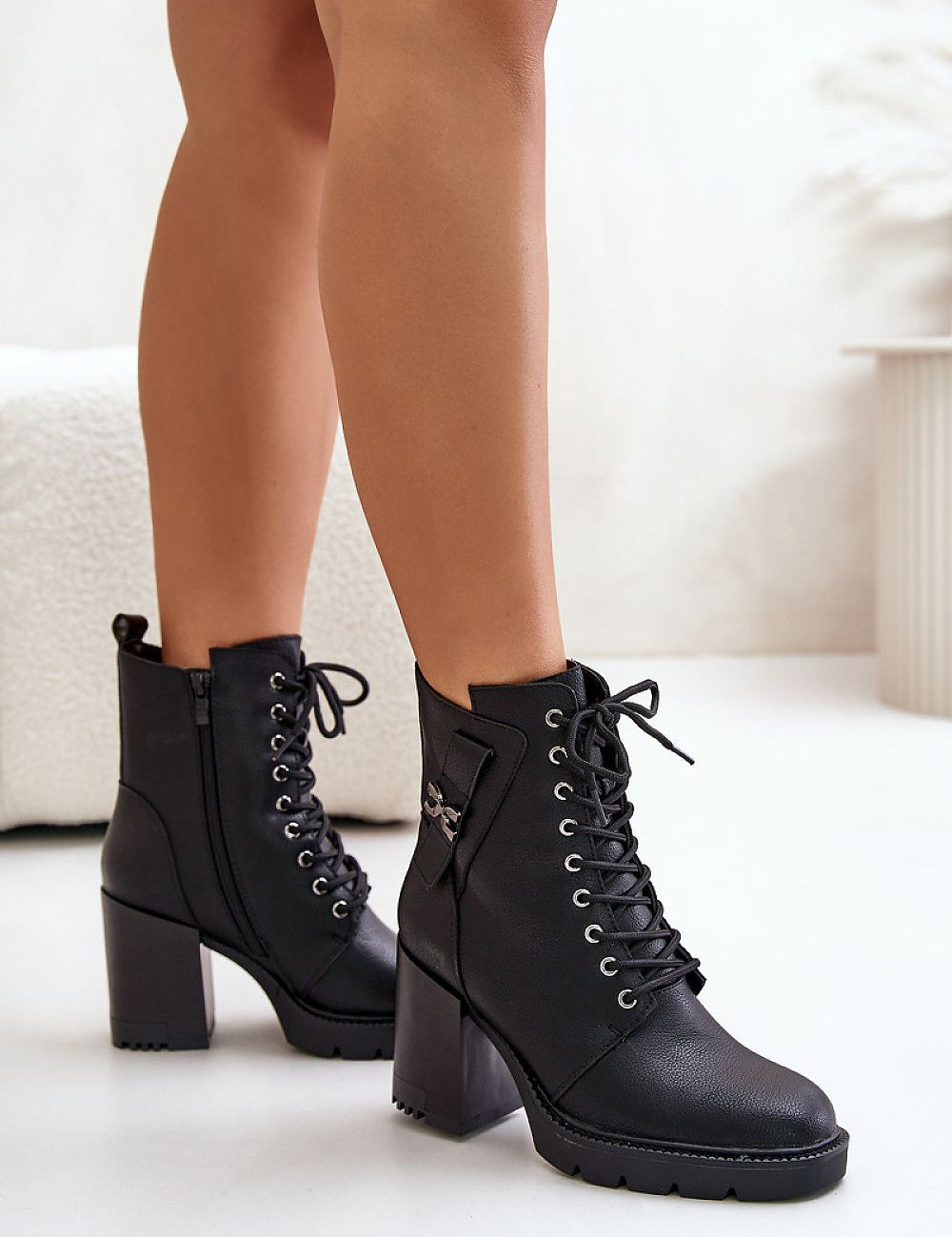 Black Noctera Luxe Zip-Up Heeled Boots with block heel, eco leather finish, lacing, side zip, and gold-accented strap for winter.