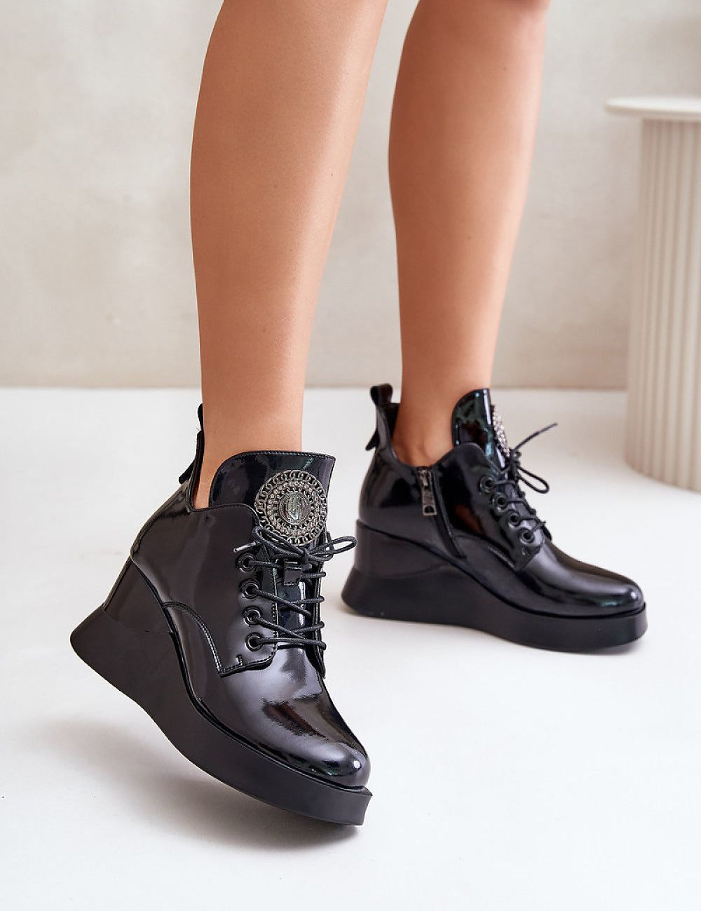 Elegant Tavendra platform boots with sleek natural leather, bold block heel, side zipper, and unique tongue embellishment.