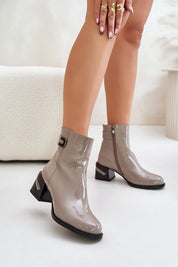 Stylish patent leather ankle boots with side zipper, block heel, and a modern glossy finish.