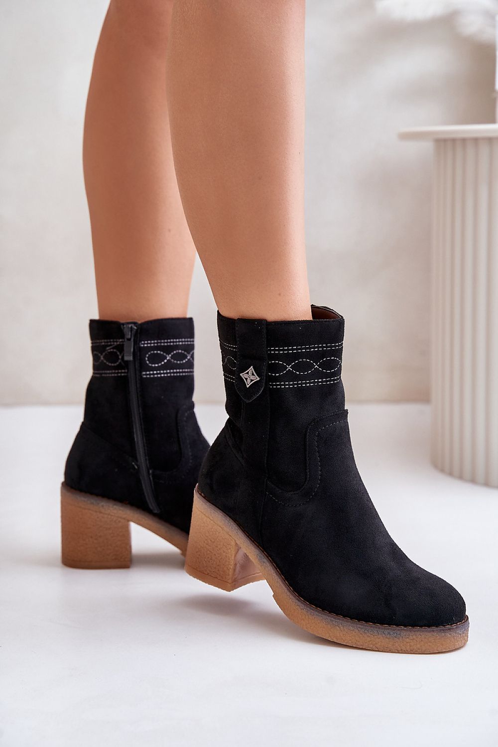 Evirenna suede-stitched heel boots in black eco-suede with block heel and rounded toe, showcasing subtle stitching accents.