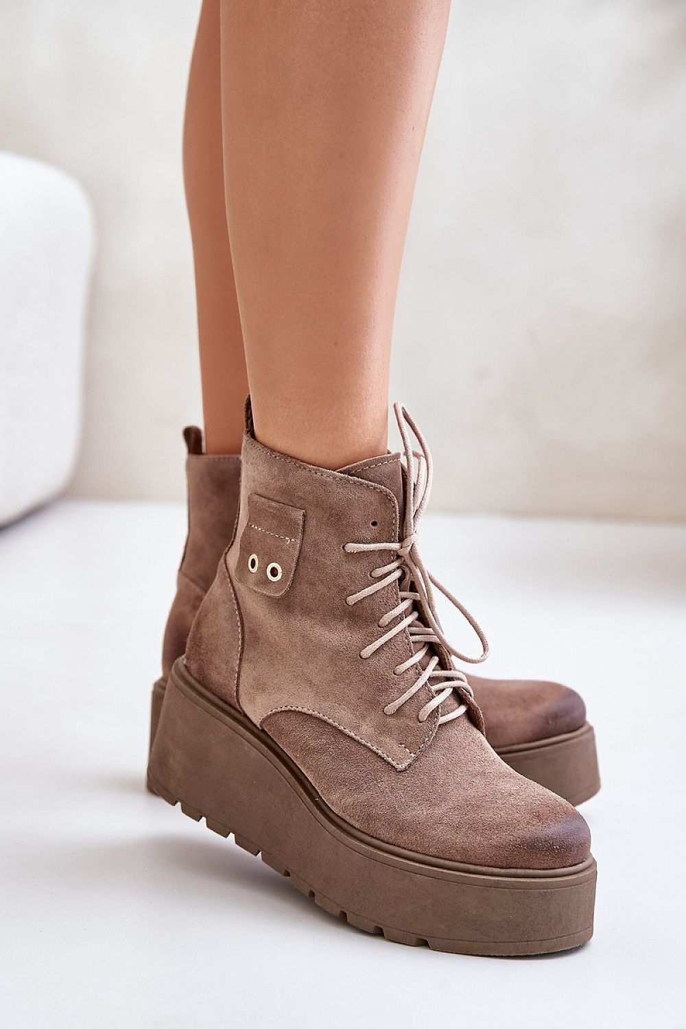 Tharvene Ridgewarm Sculpted Ease buskin-style ankle boots with high wedge and grooved platform, showcasing decorative detail and side zipper.