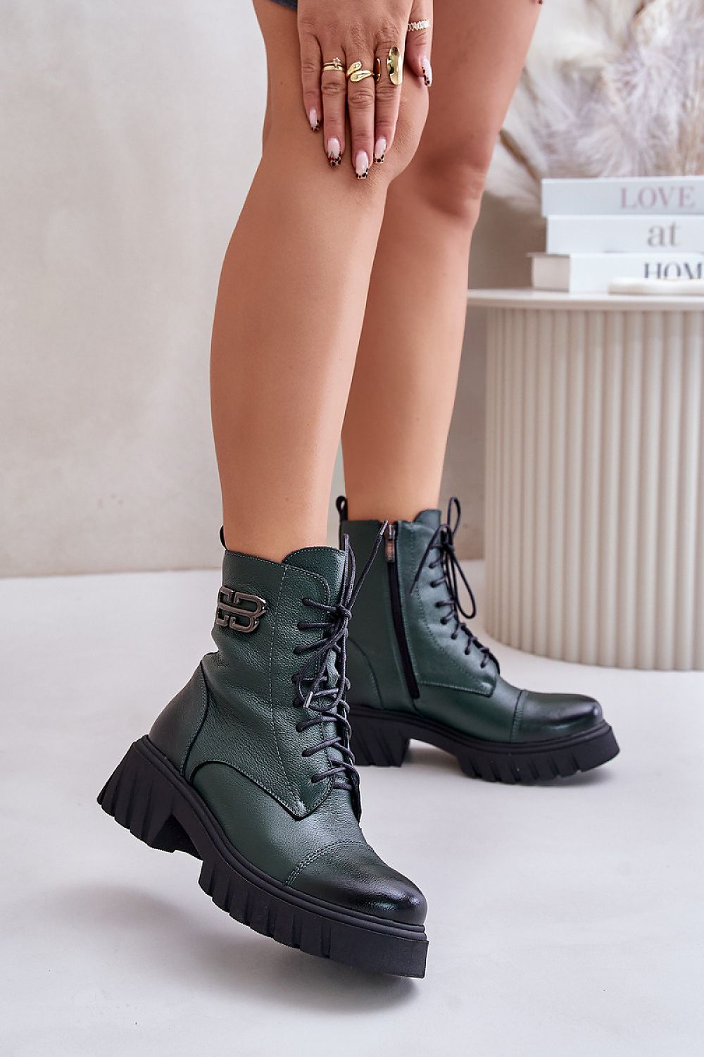 Green leather platform boots with laces and side zipper, featuring a bold sole and golden accent, perfect for autumn and winter styling.