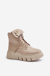 Kaelith leather platform boots with front lacing, side zipper, rounded toes, and safety pin accent for urban edge and winter warmth.