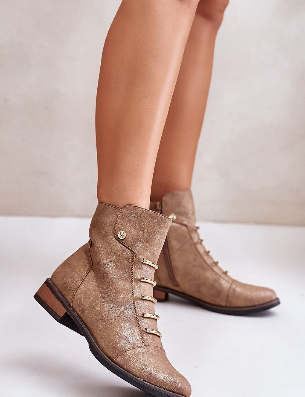 Tan ankle boots with side zipper and flat heel, showing minimalist design and eco leather finish, perfect for casual outings.