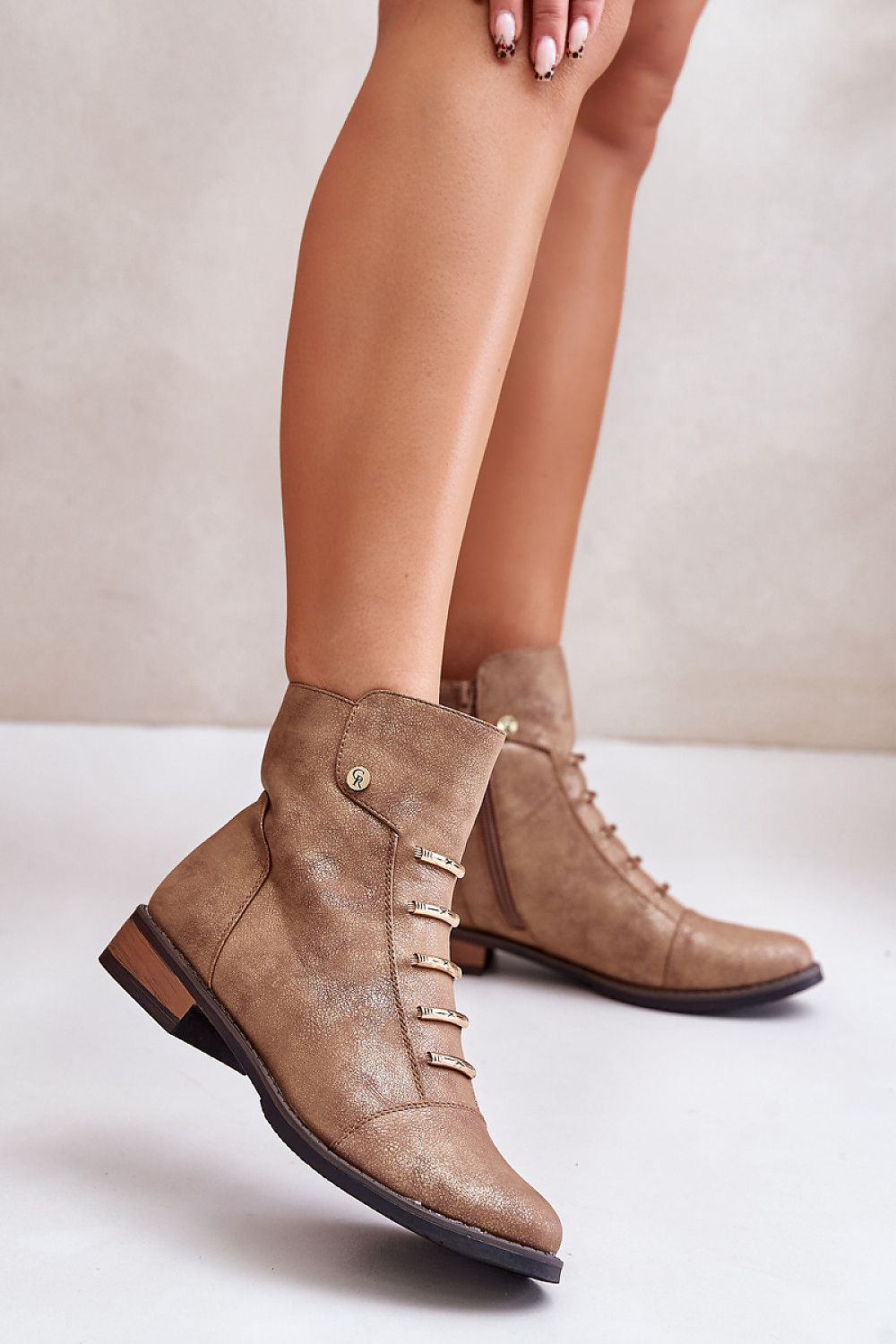 Tan ankle boots with side zipper and flat heel, showing minimalist design and eco leather finish, perfect for casual outings.