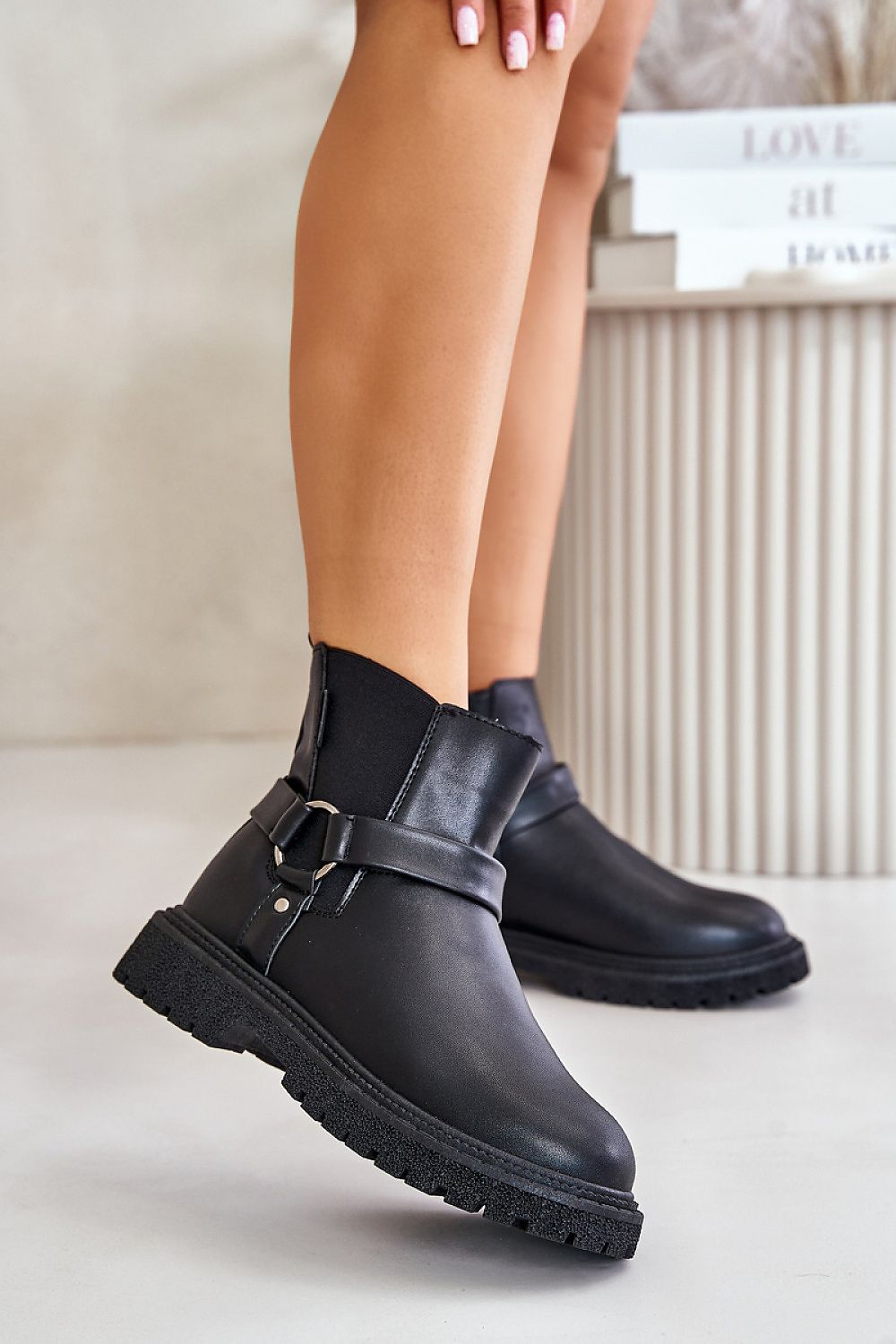 Black jodhpur boots with a side zipper and triple-stripe on model, featuring rounded toe and 3.5 cm heel for daily comfort.