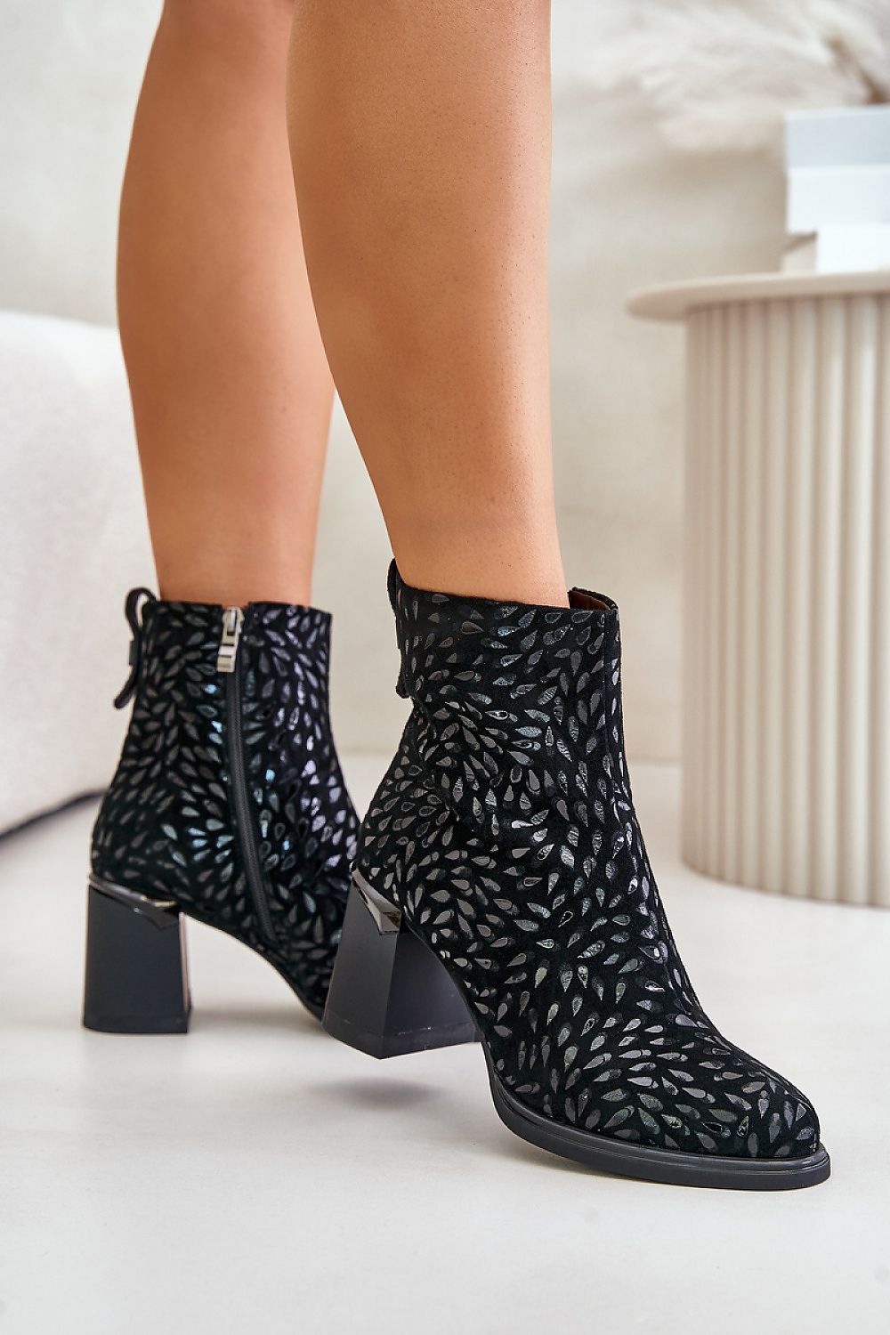 Alt Tag: Celvaria embossed suede heel boots with textured pattern and block heel, featuring side zipper and rounded toe.