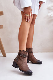 Olivaya eco-leather mid heel ankle boots with zipper, shown on woman, featuring post-style heel and decorative stripe.