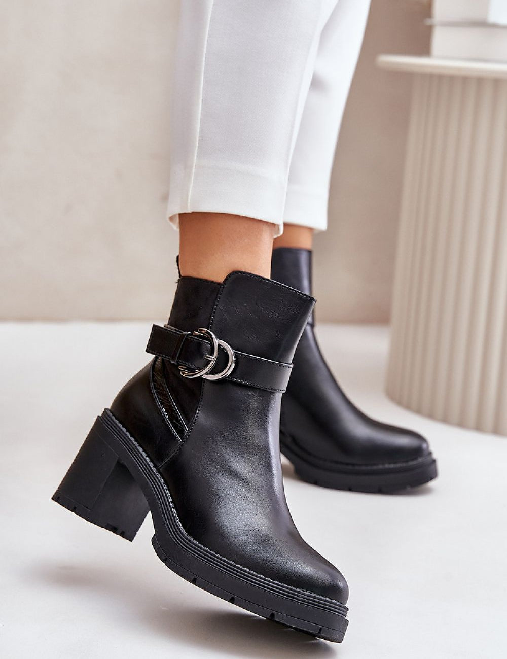 Velona heeled winter boots in black eco leather with a buckle strap, featuring post heels for stability, perfect for elegant winter style.