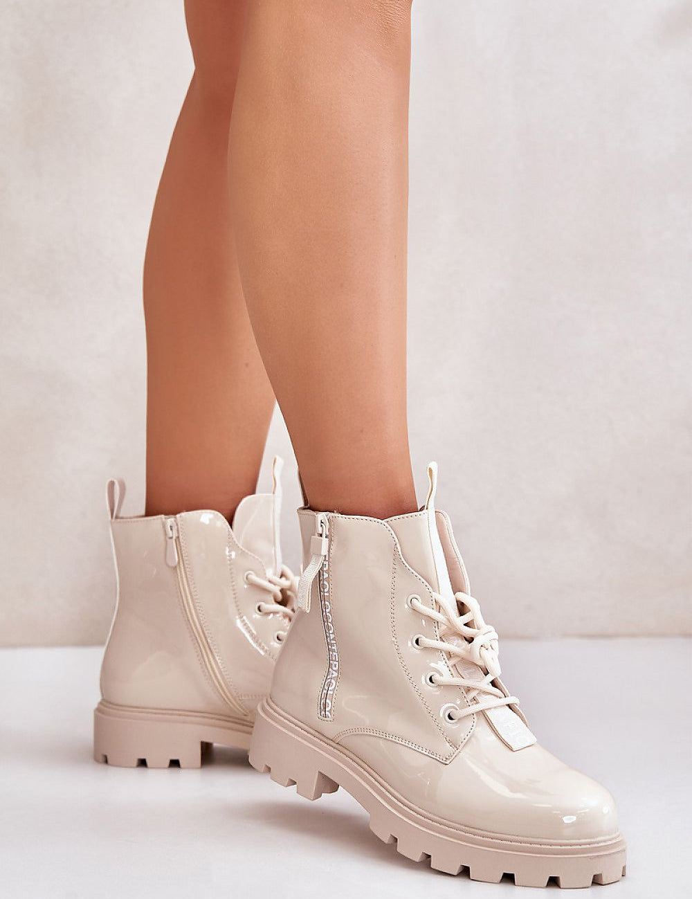 Beige insulated lace-up boots with side zipper, eco-friendly artificial leather, cozy lining, and rugged sole for winter wear.