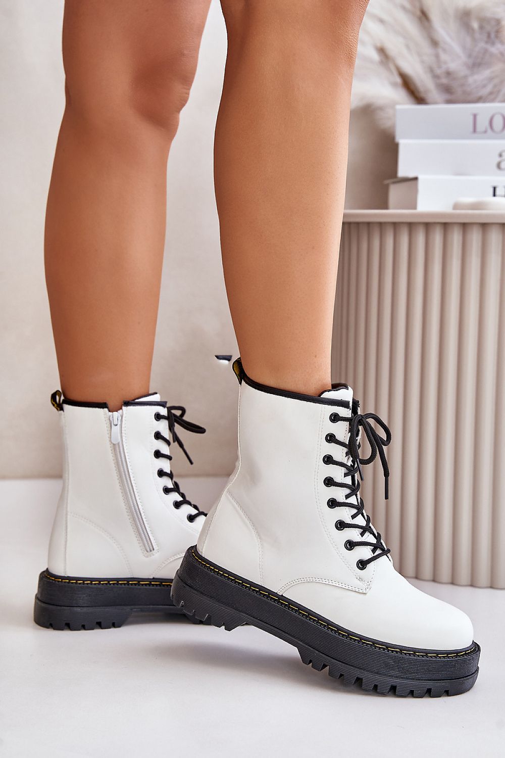 Woman wearing Liravelle Corefit insulated platform boots in white eco leather with laces and side zipper, showing comfort and support features.