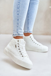 White Elbrina insulated winter sneakers with high-top design, decorative stitching, and secure lacing system, worn with light denim jeans.