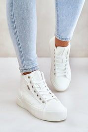 Person wearing Elbrina Insulated Winter Sneakers in white with high-top design and decorative stitching, paired with light blue jeans.