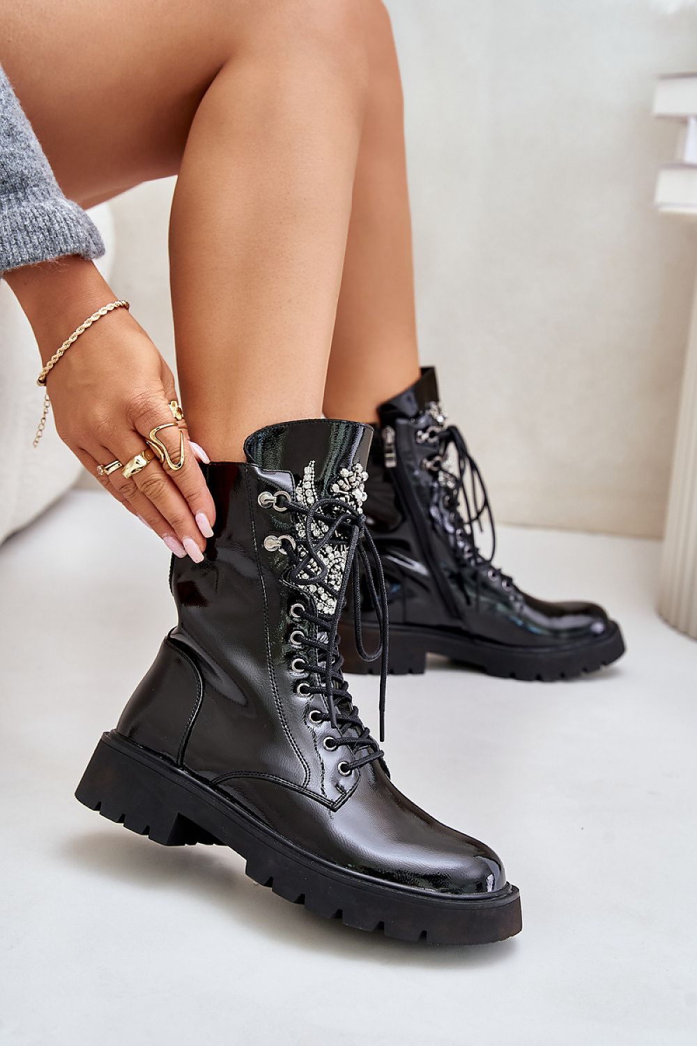 Stylish black eco-leather boots with lace and zipper, featuring embellishments, ideal for cold weather fashion.