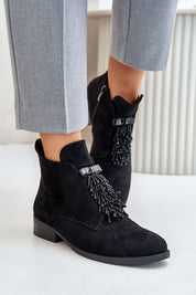 Evarine Frontglow Suede Ankle Boots with front embellishment and flat heel, styled with grey trousers on white background