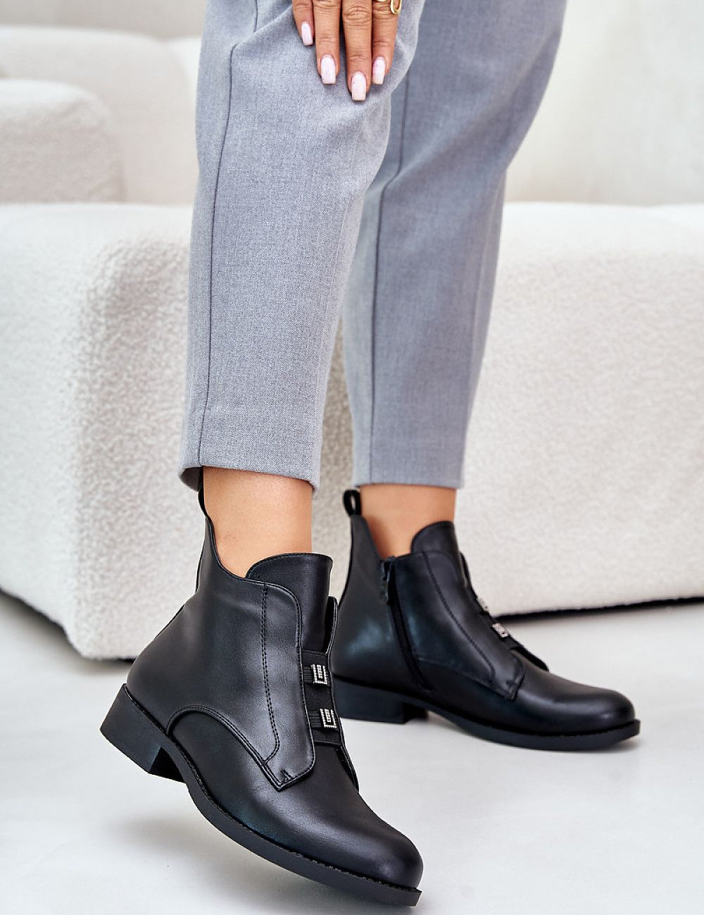 Woman wearing Dovarya Flat Eco Leather Boots with fleece lining, decorative accents, side zipper, ideal for cold weather style.