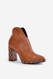 Brown leather ankle boot with geometric patterned block heel and sleek design, showcasing a modern, edgy style.