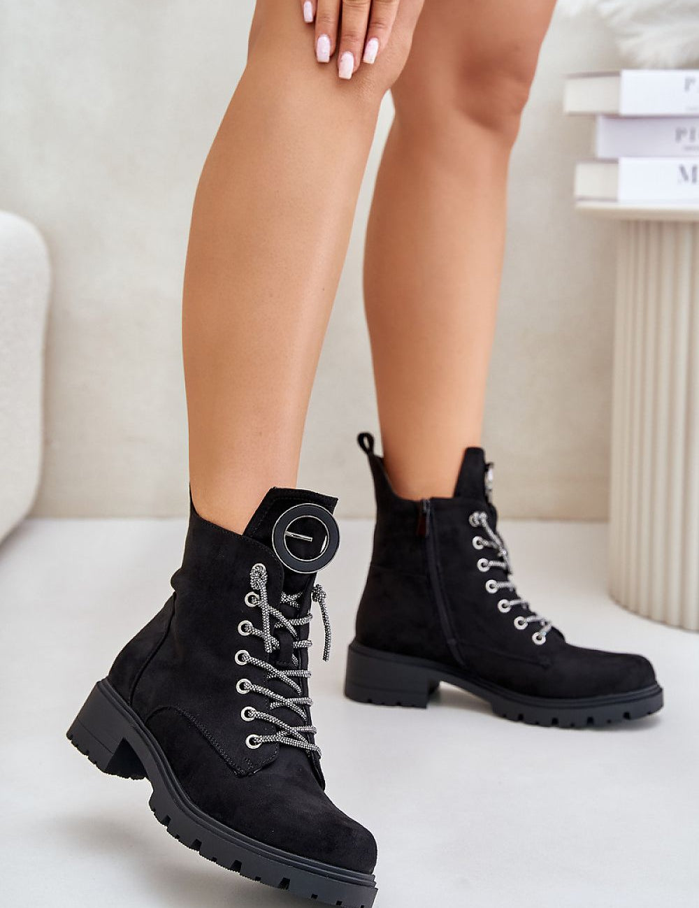 Woman wearing Virellune Frostlace Suede Rhythm boots with decorative lacing and eco-suede finish for cool-weather style.