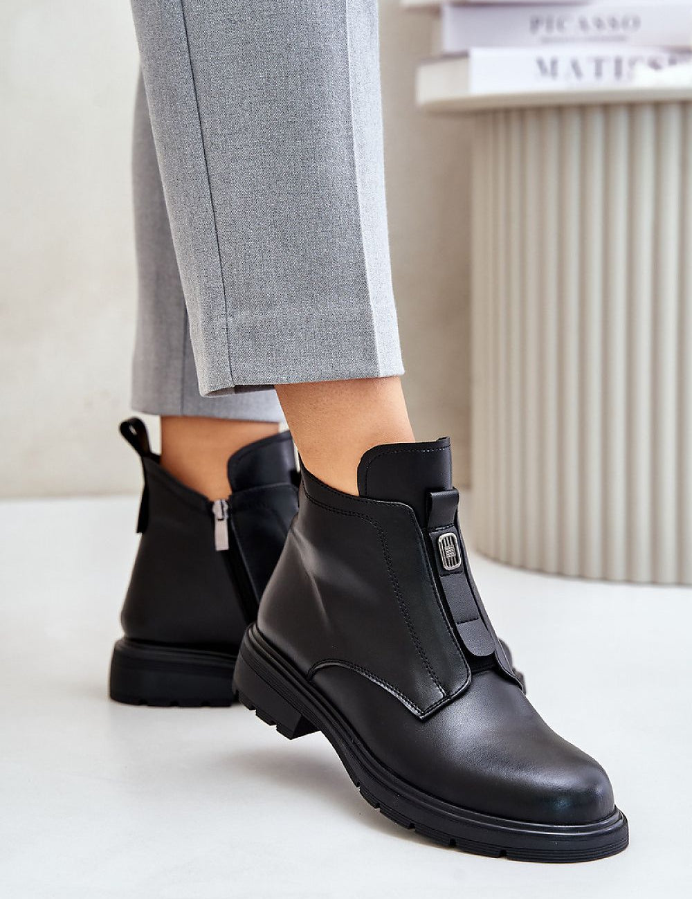 Model wearing Orlavia Flat Leather Winter Boots with side zipper and subtle decorative detail, showcasing comfort and style.