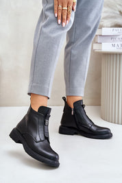 Woman wearing Orlavia flat leather winter boots with zipper, elegant design, 4 cm heel, ankle-high shaft for comfort and style.