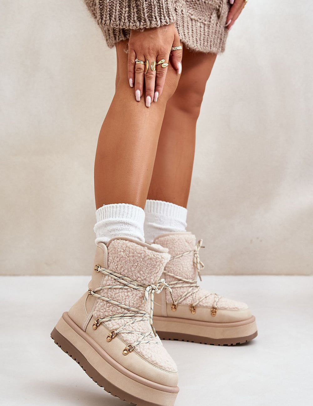 Woman wearing Glavira fur-lined platform snow boots with thick faux fur lining and laced upper, styled with cozy winter socks.