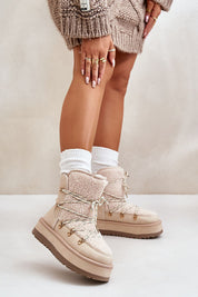 Woman wearing Glavira fur-lined platform snow boots with thick faux fur lining and laced upper, styled with cozy winter socks.