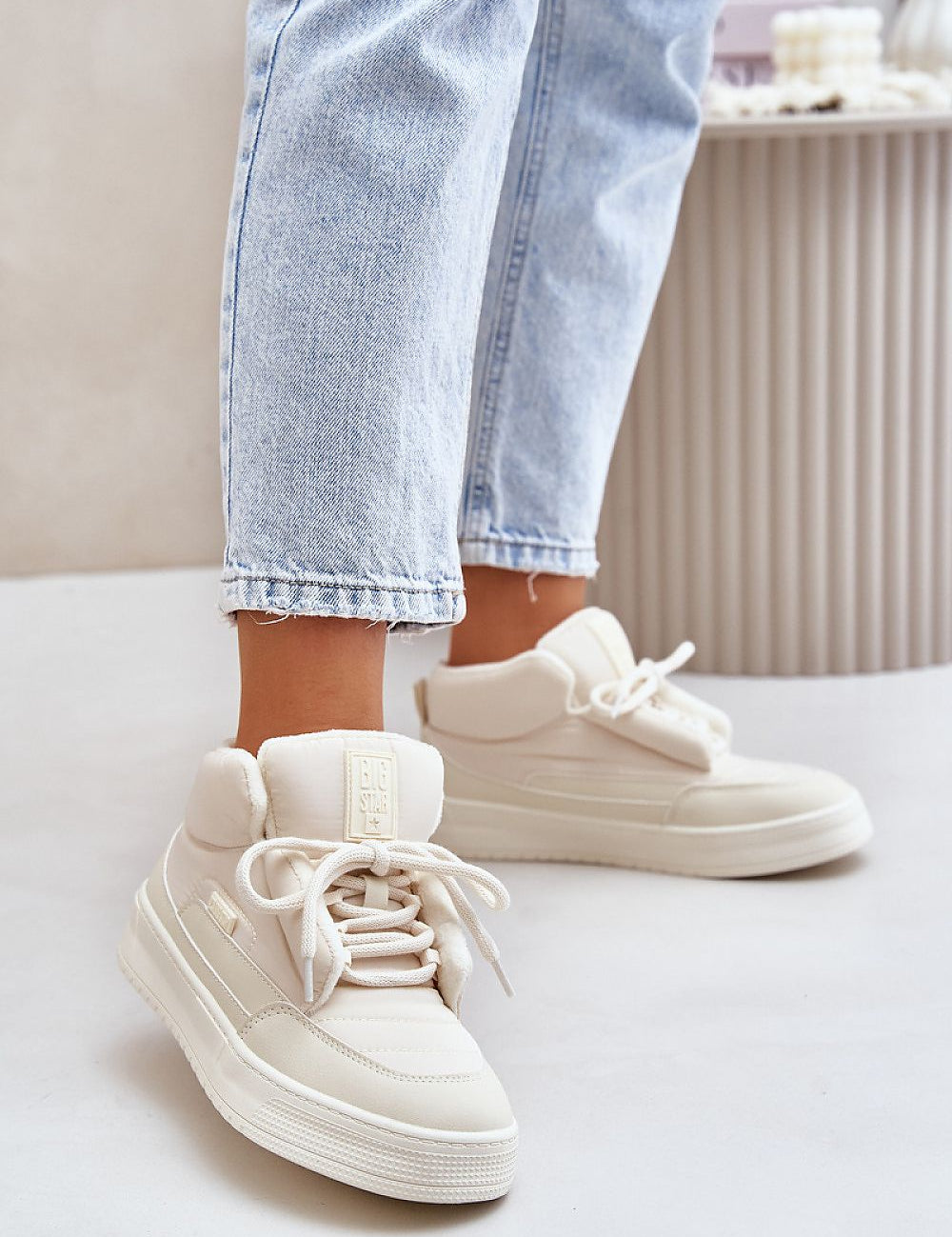 Person wearing Dovema Warm Ankle Sneakers with jeans, showcasing the stylish and insulated design for cold-weather outfits.