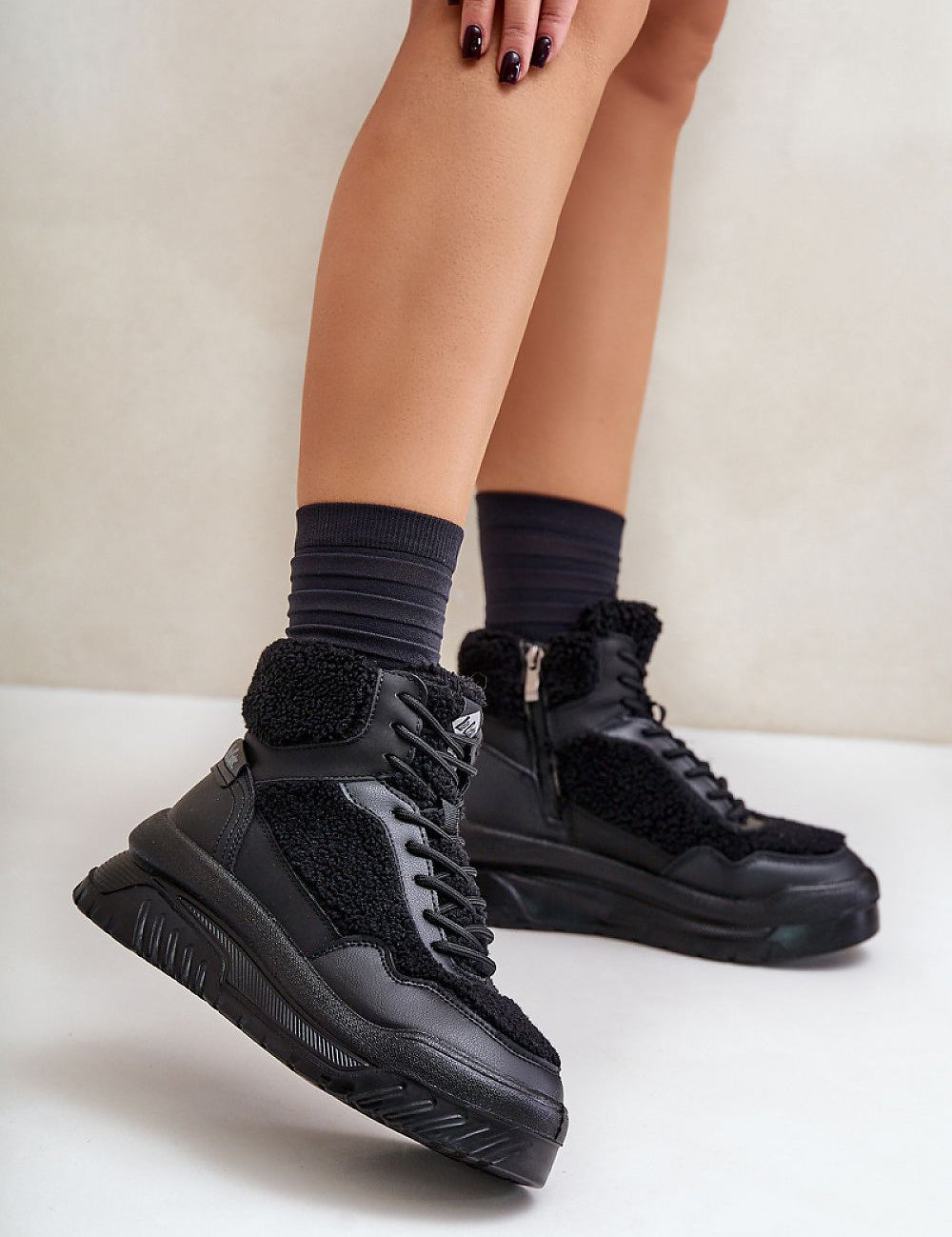 Valmara Shearling High-Top Sneakers with faux sheepskin trim, platform sole, lace and zipper closure, and cozy blanket lining.