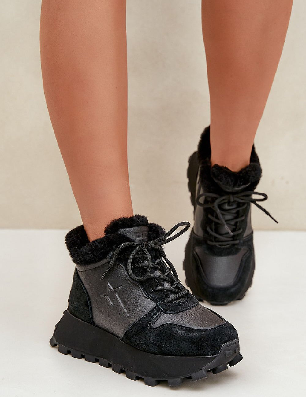 Alverra Winter Leather Sneakers in black, featuring plush fur lining, raised platform sole, and side zipper for cold-weather style and comfort.