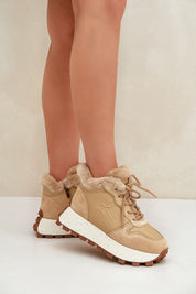 Woman wearing Alvarra Leather Platform Winter Sneakers in tan with fur lining for warmth and a 3.5 cm platform for added height.